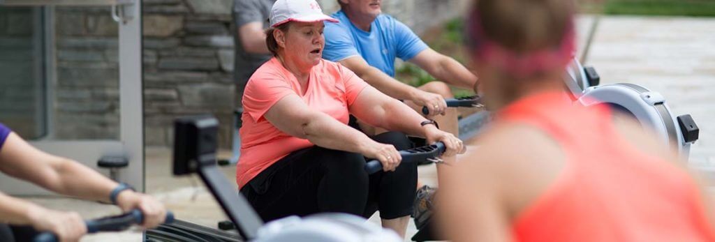 woman on rowing machine in class